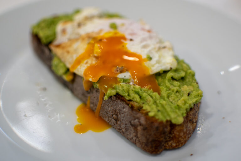 high protein avocado egg toast with fried egg and chili flakes