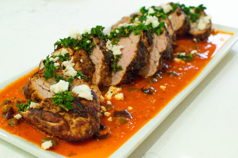 mediterranean pork tenderloin sliced over roasted red pepper sauce with herb gremolata