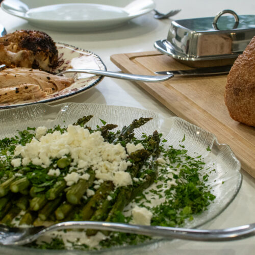 roast chicken with crispy asparagus and lemon shallot yogurt sauce on a sheet pan