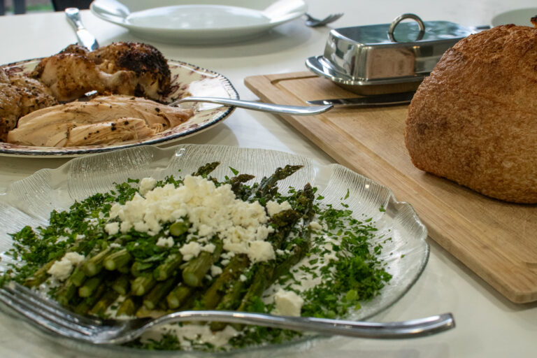 roast chicken with crispy asparagus and lemon shallot yogurt sauce on a sheet pan