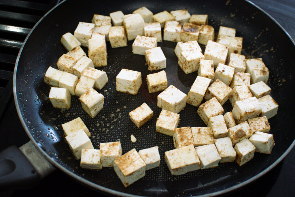 crispy pan-seared tofu cubes in a skillet Secondary