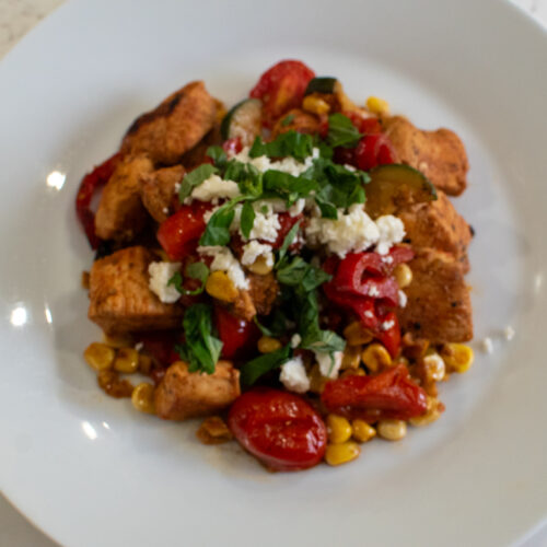 High protein chicken skillet with zucchini, bell peppers, corn, and cherry tomatoes