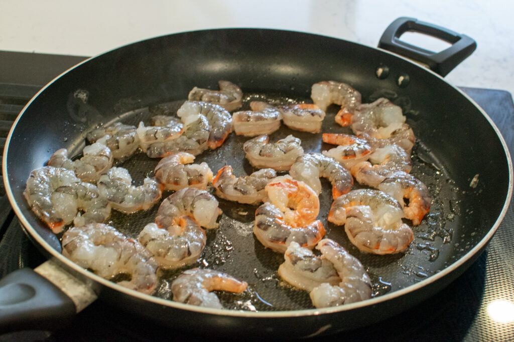 shrimp searing in a skillet for low carb shrimp stir fry