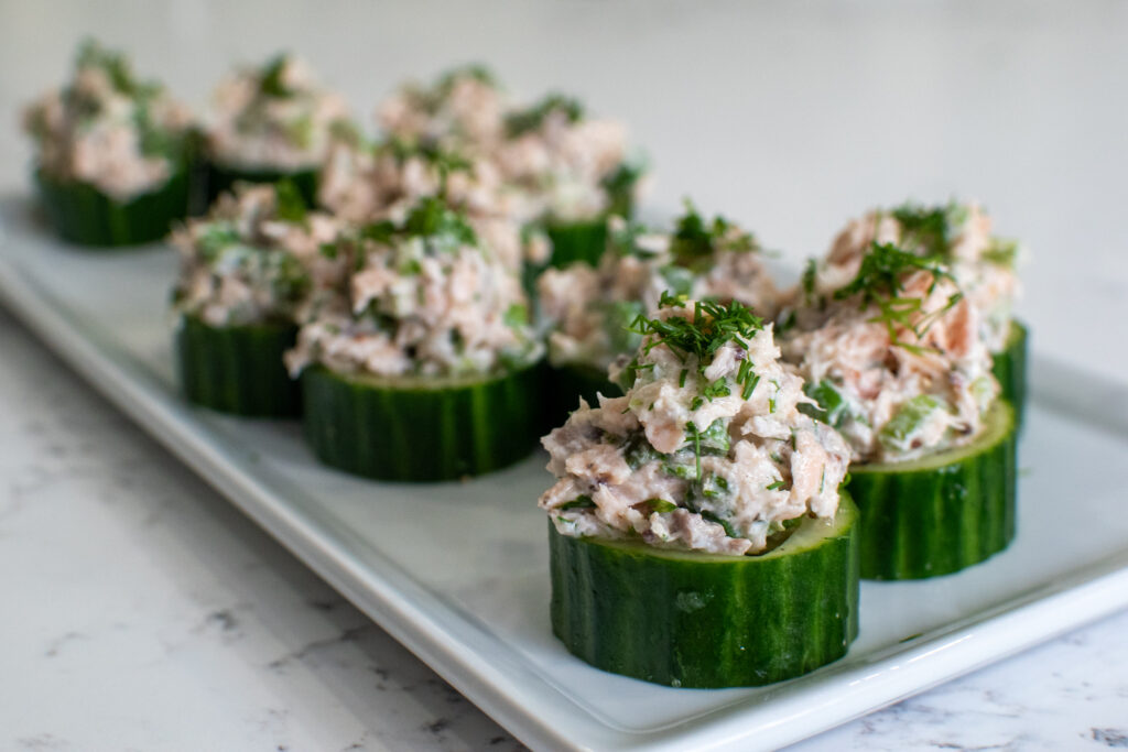 Leftover salmon salad in cucumber cups, garnished with dill and lemon zest